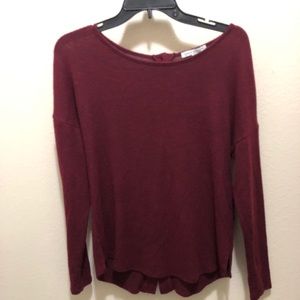 Red long sleeve with buttons in the back